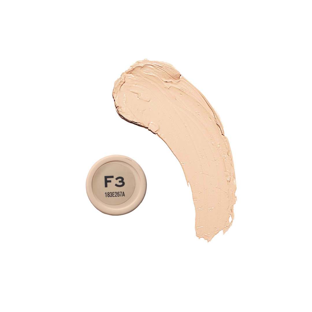 Revolution Fast Base Stick Foundation in a sleek stick format, showcasing a creamy texture and rich pigmentation.