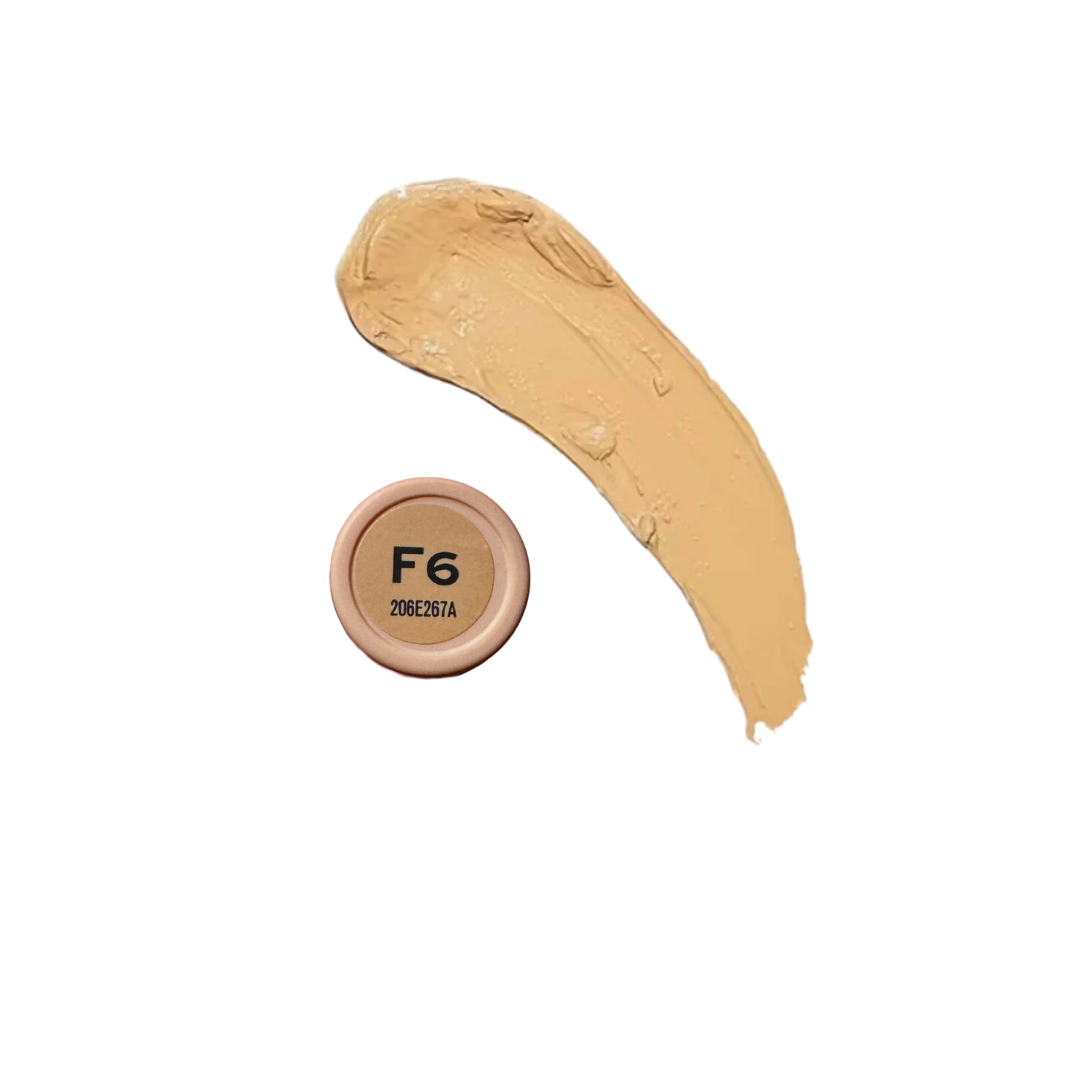 Revolution Fast Base Stick Foundation in a sleek tube, displaying its creamy texture and rich color for flawless coverage.