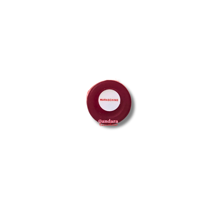 Revolution Maraschino Cherry Liquid Lipstick in a sleek tube, showcasing vibrant red color and smooth texture.